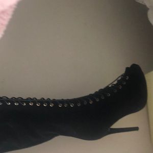 Thigh high lace up boots.